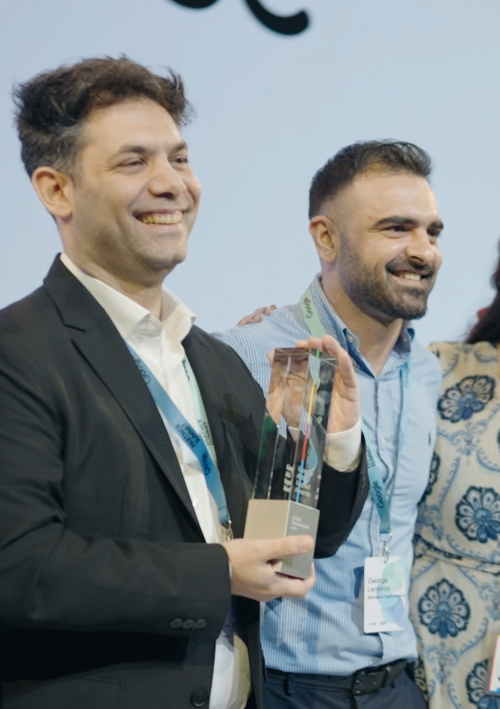 Alex Schizas holding the award